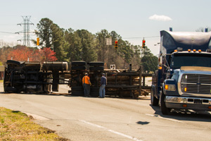 Logging truck turned over on highway