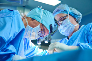 The surgeon's team performs an operation