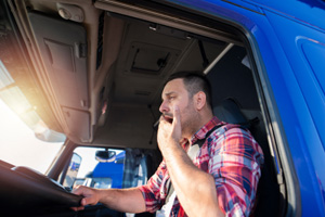 Truck driver yawning while driving