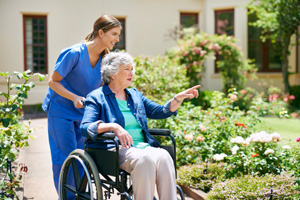 resident and a nurse outside in the nursing home