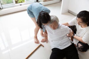 Asian elderly people with walking stick on floor after falling d